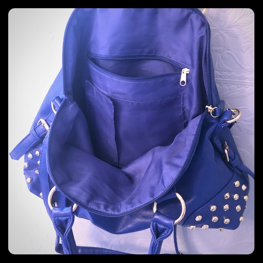 Bright cobalt blue purse with gold studs.